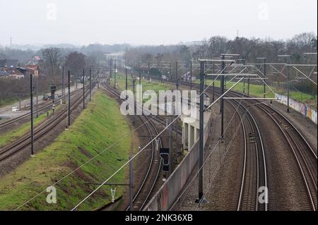 Kessel-Lo, Flemish Brabant, Belgium - Feb 11 2023 - High angle view over railwaytracks towards the train station Stock Photo