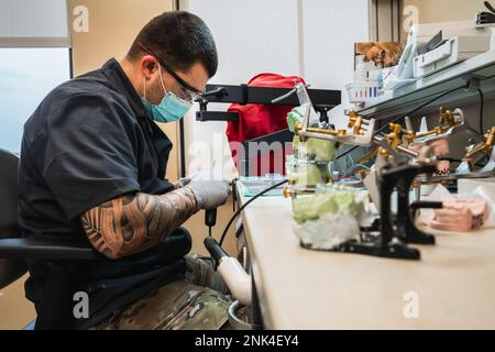 U.S. Air Force Senior Airman Austin Wright, 6th Medical Group dental laboratory technician, fabricates an acrylic appliance used to protect enamel on teeth at MacDill Air Force Base, Florida, Aug. 11, 2022. Air Force dental laboratory technicians assist dentists by crafting and creating custom dental prostheses with materials such as acrylic, gypsum and gold. Airman Magazine,Dental,Health,Medical,Military Health, Stock Photo