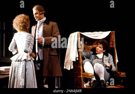 Cherubino witnesses Almaviva proposition Susanna - l-r: Lesley Garrett (Susanna), Steven Page (Count Almaviva), Ethna Robinson (Cherubino) in THE MARRIAGE OF FIGARO at English National Opera (ENO), London Coliseum, London WC2  05/1990  music: Wolfgang Amadeus Mozart  libretto: Lorenzo da Ponte  English version by Edward J Dent  conductor: Michael Lloyd  set design: Patrick Robertson  costumes: Rosemary Vercoe  lighting: David Hersey & Paul Taylor  choreographer: Terry John Bates  original director: Jonathan Miller  revival director: Rebecca Meitlis Stock Photo