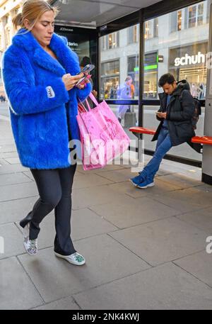 London, England, UK. A man and a woman on their mobile phones Stock Photo