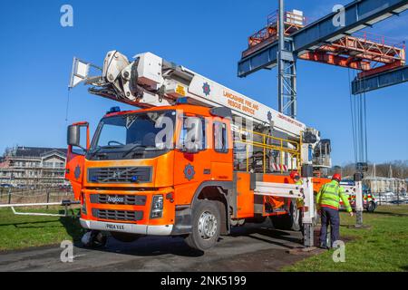 Lancashire Fire and Emergency Rescue Team on a training day at Maritime Way, Preston Docks. using a Bronto Skylift, Heavy Duty Telescopic (HDT) all-round aerial ladder platform mounted on a 2004 Red VOLVO FM Angloco Truck. The full-time Fire Crew who work 2 days on, & 2 nights on, practice and hone their skills by launching a Zodiac Rib boat and ascending the boat lift situated at Preston Docks, Riversway, UK Stock Photo