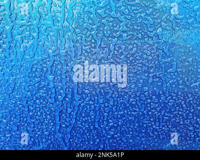 Close up of ice overlay on blue metal background Stock Photo