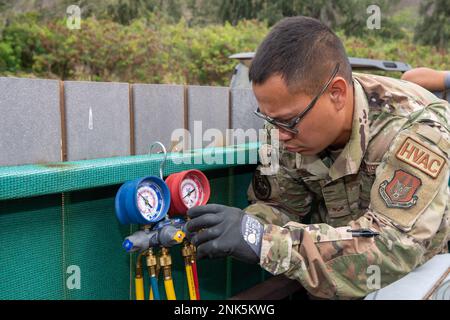 Senior Airman Veron Ceno checks the refrigerant pressure on a manifold gage to ensure levels are safe to replace an HVAC system. The 624th Civil Engineer Squadron (CES) spent their annual tour inspecting and replacing HVAC system at Bellows Air Force Station, Aug. 12, 2022. The CES had the opportunity to built-up unit readiness and maintain the facilities so active duty members, military retirees, Reservists, National Guard and DoD employees can enjoy what Bellows AFS has to offer. 624th Civil Engineer Squadron,Bellows Air Force Station,CES,HVAC system, Stock Photo