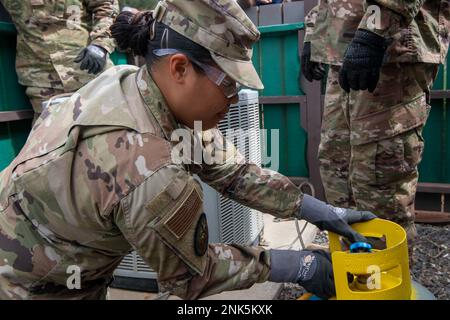 Airman 1st Class Jamie Mercado extracts refrigerant from an HVAC system prior to replacing it. The 624th Civil Engineer Squadron (CES) spent their annual tour inspecting and replacing HVAC system at Bellows Air Force Station, Aug. 12, 2022. The CES had the opportunity to built-up unit readiness and maintain the facilities so active duty members, military retirees, Reservists, National Guard and DoD employees can enjoy what Bellows AFS has to offer. 624th Civil Engineer Squadron,Bellows Air Force Station,CES,HVAC system, Stock Photo