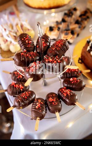 sweets, cake and cookies sweet on a stick in chocolate with sprinkles Stock Photo