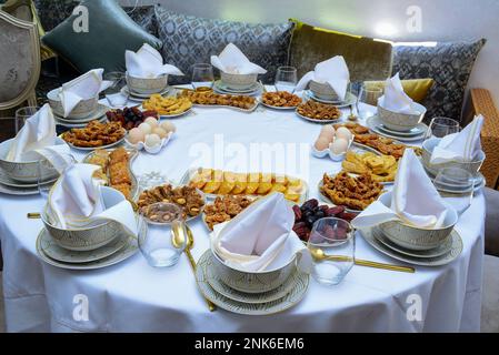 Moroccan Algerian breakfast table. Vintage background with different plates with delicious traditional middle eastern food Stock Photo