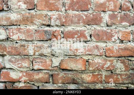 Red uneven brick wall backgroundold. Closeup horizontal Stock Photo