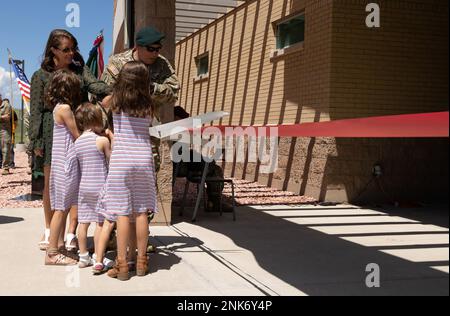 Sarah Lindsay, widow of Fallen Green Beret Sgt. 1st Class Will Lindsay, and their four daughters cut a ribbon to unveil Lindsay Hall on Fort Carson, Colorado, Aug. 11, 2022. The 2nd Battalion, 10th Special Forces Group (Airborne), operations facility was named in honor of Lindsay, a Special Forces intelligence sergeant who died March 22, 2019, in Kunduz, Afghanistan, as a result of wounds sustained while engaged in combat operations as part of the Operation Freedom’s Sentinel. Stock Photo