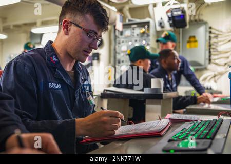 220811-N-GF955-1011  ATLANTIC OCEAN (Aug. 11, 2022) Damage Controlman 2nd Class Sean Bogan, from Old Bridge, N.J., left, conducts engineering drills and evolutions from central control station (CCS) aboard the Arleigh Burke-class guided-missile destroyer USS Paul Ignatius (DDG 117), Aug. 11, 2022. Paul Ignatius, forward-deployed to Rota, Spain, is on a scheduled deployment in the U.S. Naval Forces Europe area of operations, employed by U.S. Sixth Fleet, to defend U.S., allied and partner interests. Stock Photo