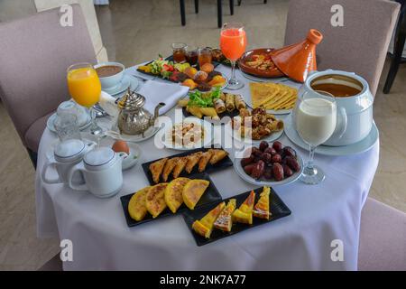 Moroccan Algerian breakfast table. Vintage background with different plates with delicious traditional middle eastern food Stock Photo