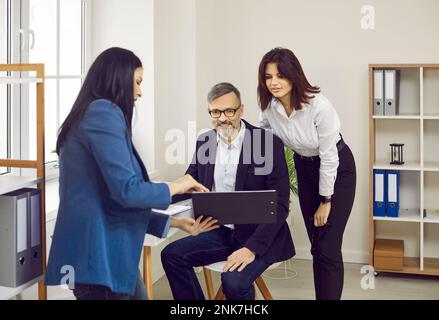 Business people looking at clipboard with interest while working in office Stock Photo