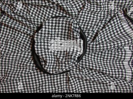 Background texture, pattern. Scarf wool like Yasser Arafat. The Palestinian keffiyeh is a gender-neutral checkered black and white scarf that is usual Stock Photo