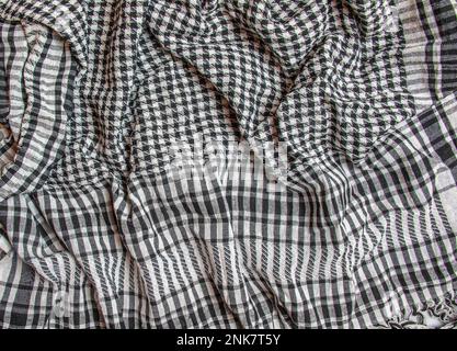 Background texture, pattern. Scarf wool like Yasser Arafat. The Palestinian keffiyeh is a gender-neutral checkered black and white scarf that is usual Stock Photo