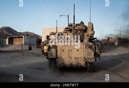 U.S. Soldiers assigned to 1st Battalion, 18th Infantry Regiment, 2nd Armored Brigade Combat Team, 1st Infantry Division maneuver a Bradley Fighting Vehicle to a defensive position during Decisive Action Rotation 22-09 at the National Training Center, Fort Irwin, Calif., Aug 11th, 2022. Stock Photo