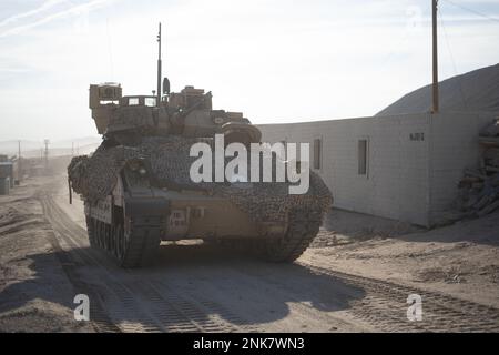 U.S. Soldiers assigned to 1st Battalion, 18th Infantry Regiment, 2nd Armored Brigade Combat Team, 1st Infantry Division maneuver a Bradley Fighting Vehicle through the town of Razish during Decisive Action Rotation 22-09 at the National Training Center, Fort Irwin, Calif., Aug 11th, 2022. Stock Photo