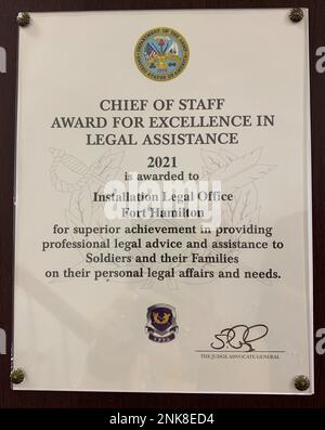 The Army Chief of Staff Award for Excellence in Legal Assistance plaque hangs on a wall inside the Installation Legal Office at Fort Hamilton, N.Y. August 12, 2022. The Fort Hamilton Installation Legal Office’s ability to assist eligible clients with managing their personal legal affairs in a timely and professional manner, thereby promoting readiness, high morale, discipline, and a quality force, has earned them Army-level recognition. Stock Photo