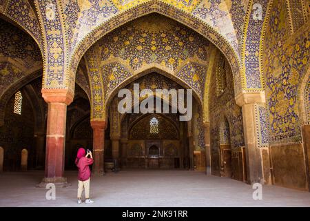 Isfahan, Iran - 15th may, 2022: female tourist explore courtyard Friday Mosque (Jame Mosque Of Isfahan) Stock Photo