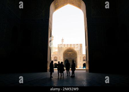 Isfahan, Iran - 15th may, 2022: group of tourist with guide explore courtyard Friday Mosque (Jame Mosque Of Isfahan) Stock Photo