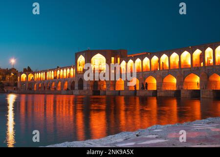 Isfahan, Iran - 15th june, 2022: tourist muslim visit Old Khajoo bridge at night, across the Zayandeh River in Isfahan, Iran. Stock Photo