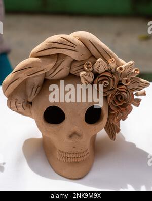 Ceramic skull with flowers celebrating Day of the Dead in a ceramic workshop in Santa Maria Atzompa, Oaxaca, Mexico. Stock Photo