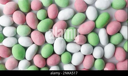 Background of multicolored small chocolate candies, glazed nuts. Close-up, top view Stock Photo