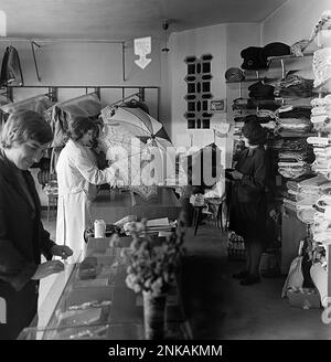 Socialist Republic of Romania, approx. 1980. Employees in a retail store showcasing their merchandise. The Socialist -era economy was centralized. Stock Photo