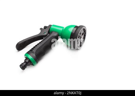 Green and black plastic watering gun on a white background with copy space Stock Photo