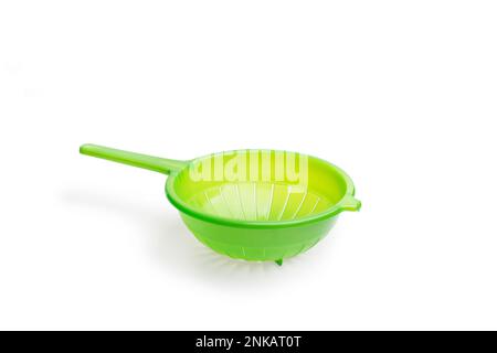 A green plastic strainer on a white background with copy space Stock Photo