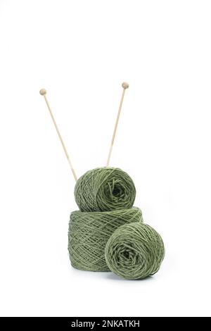 Green wool ball and knitting needles on a white background with copy space Stock Photo