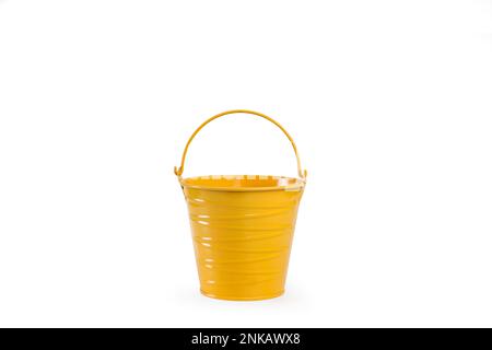 A yellow metal bucket with handle on a white background with copy space Stock Photo