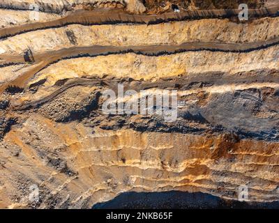 Stone quarry aerial drone view in winter sun Stock Photo