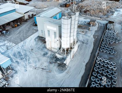 Cement pipes and products factory with solar panels installed on top, aerial view Stock Photo