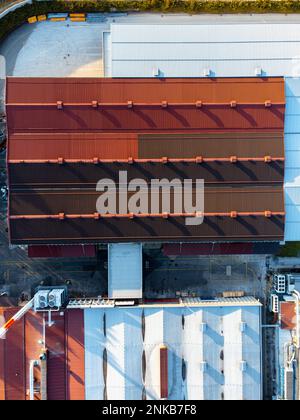 Top down view of a warehouse with a red roof, industrial site. Stock Photo