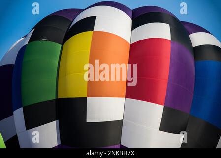 Bold and garish colors and patterns of hot air balloons. Stock Photo
