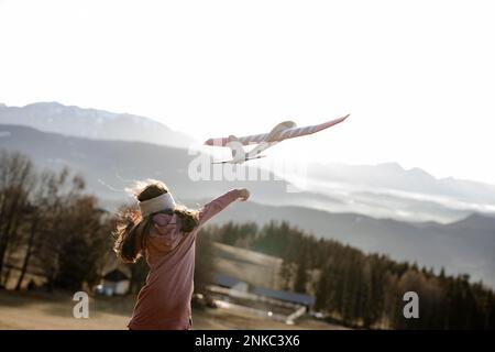 Girl playing with model glider Stock Photo