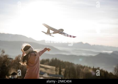 Girl playing with model glider Stock Photo