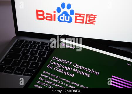 ChatGPT chat bot login screen seen on tablet and blurred Baidu company logo on the background laptop. Concept for competition. Stafford, United Kingdo Stock Photo