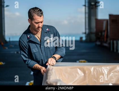 220813-F-LN908-0023  DAR ES SALAAM, Tanzania (Aug. 13, 2022) Logistics Specialist 2nd Class Ken Lee, from Clio, Mich., prepares a box for trash aboard the Lewis B. Puller-class expeditionary sea base USS Hershel 'Woody' Williams (ESB 4), Aug. 13, 2022. Hershel “Woody” Williams is rotationally deployed to the U.S. Naval Forces Africa area of operations, employed by U.S. Sixth Fleet, to defend U.S., allied and partner interests. Stock Photo