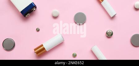Different batteries on pink background, top view Stock Photo