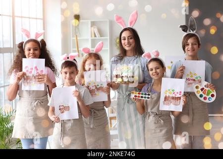 Children and teacher during master-class in art studio on Easter eve Stock Photo