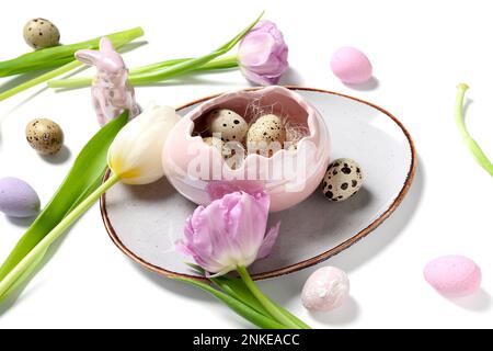 Tulip flowers and decorative shell with Easter quail eggs on white ...