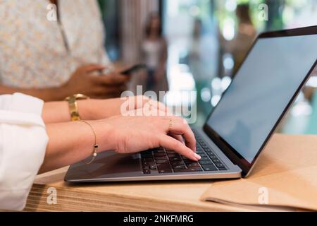 Hands of businesswoman typing on laptop Stock Photo