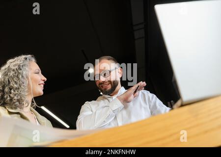 Two smiling colleagues working together in office Stock Photo