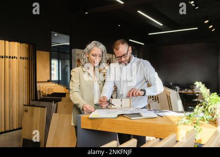Two colleagues working on project in architect's office together Stock Photo