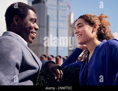 Happy business colleagues discussing together Stock Photo