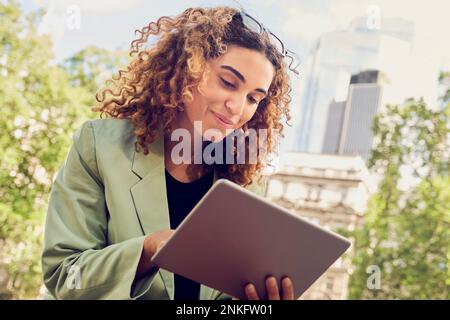 Smiling businesswoman using tablet PC Stock Photo
