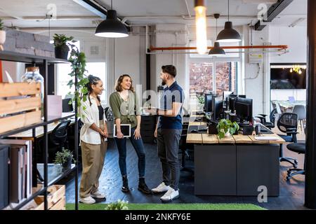Happy business people standing together in office Stock Photo
