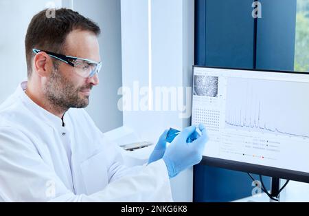 Scientist analyzing sample in a microbiological lab Stock Photo