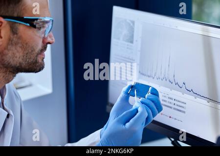 Scientist analyzing sample in a microbiological lab Stock Photo