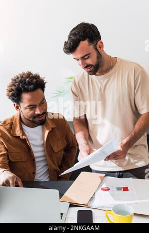 Businessmen having discussion over documents at office Stock Photo